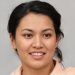 Joyful latino young-adult female with medium  brown hair and brown eyes