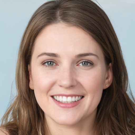 Joyful white young-adult female with long  brown hair and grey eyes