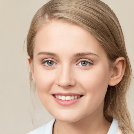 Joyful white young-adult female with medium  brown hair and blue eyes