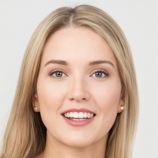 Joyful white young-adult female with long  brown hair and green eyes