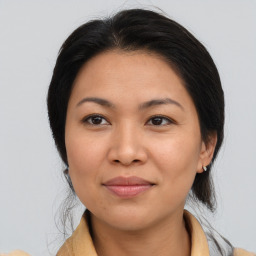 Joyful asian young-adult female with medium  brown hair and brown eyes