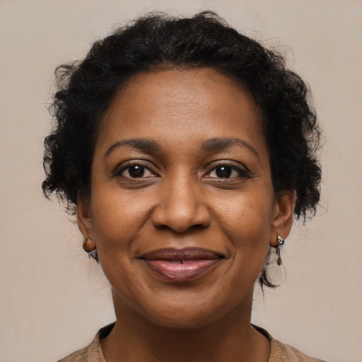 Joyful black adult female with medium  brown hair and brown eyes
