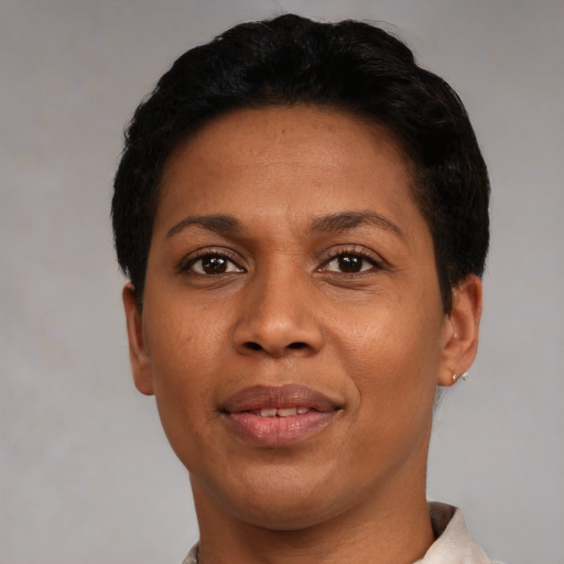 Joyful black adult female with short  black hair and brown eyes