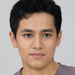 Joyful asian young-adult male with short  black hair and brown eyes