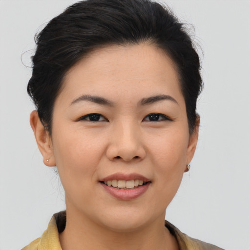 Joyful asian young-adult female with medium  brown hair and brown eyes