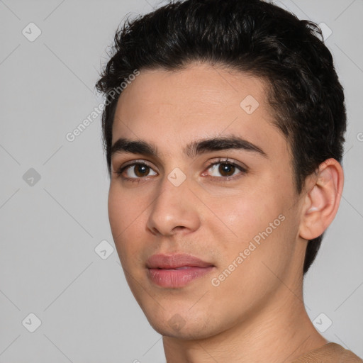 Joyful white young-adult male with short  black hair and brown eyes