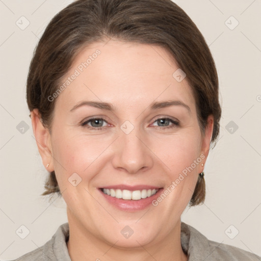 Joyful white adult female with medium  brown hair and grey eyes