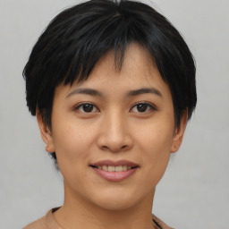 Joyful asian young-adult female with short  brown hair and brown eyes