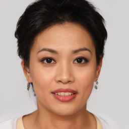 Joyful asian young-adult female with short  brown hair and brown eyes