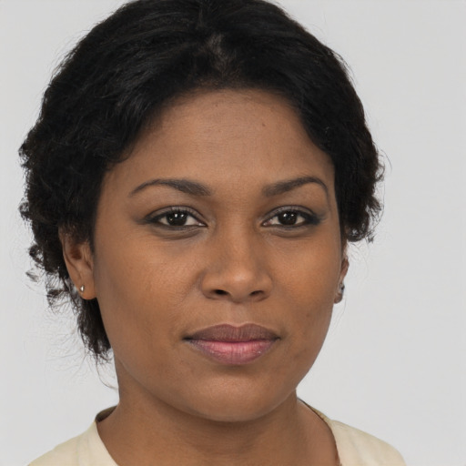 Joyful black young-adult female with short  brown hair and brown eyes