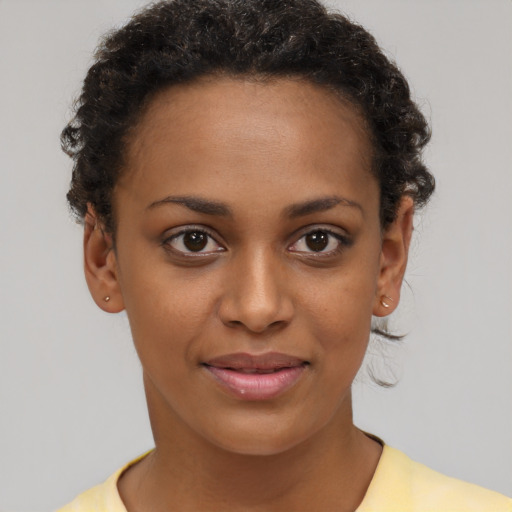 Joyful black young-adult female with short  brown hair and brown eyes