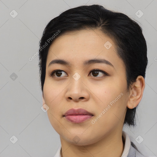 Joyful asian young-adult female with medium  black hair and brown eyes