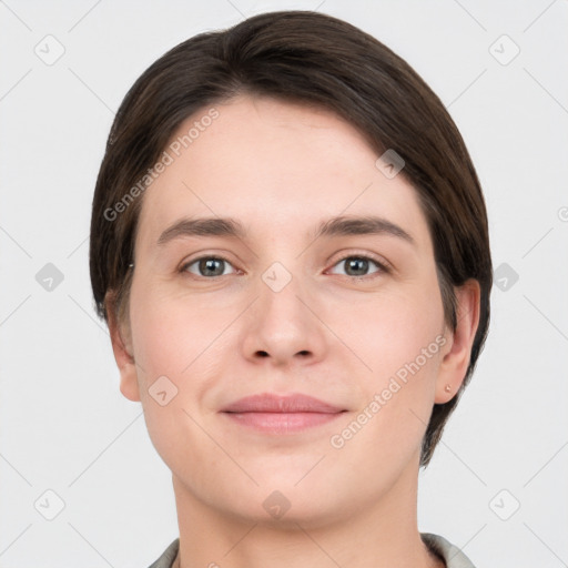 Joyful white young-adult female with short  brown hair and grey eyes