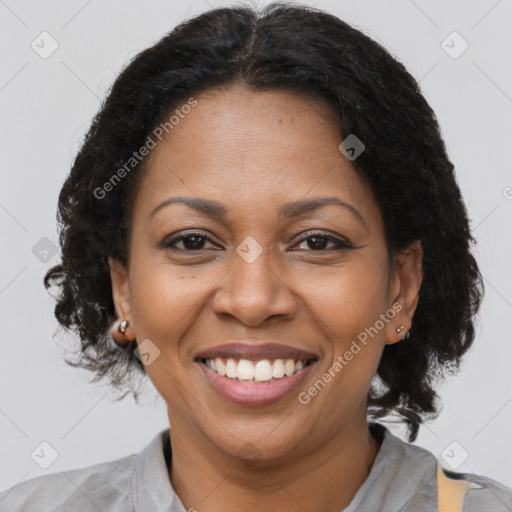 Joyful black adult female with short  brown hair and brown eyes