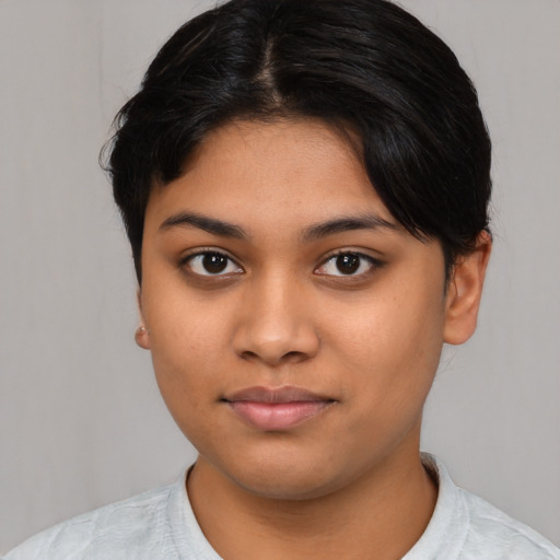 Joyful latino young-adult female with medium  black hair and brown eyes