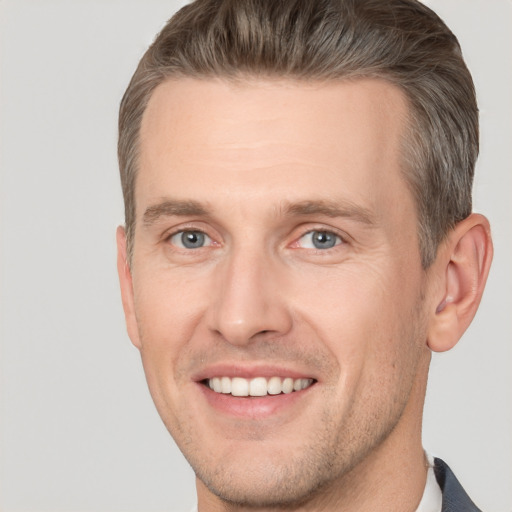 Joyful white adult male with short  brown hair and brown eyes