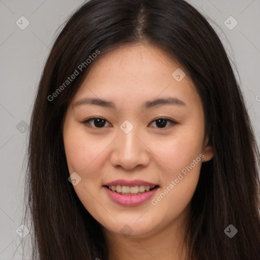 Joyful asian young-adult female with long  brown hair and brown eyes