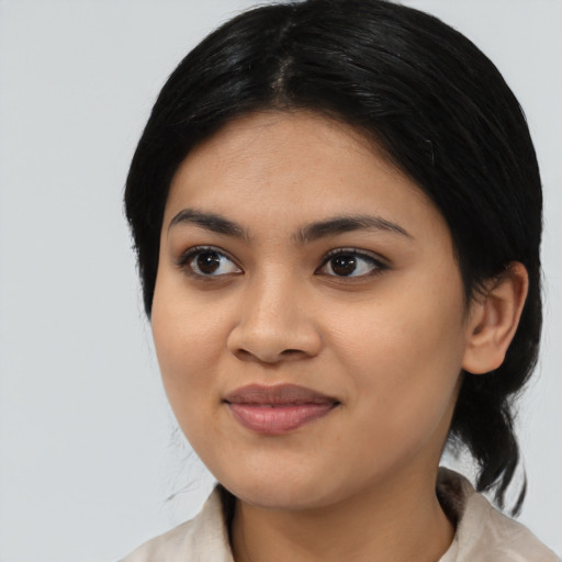 Joyful asian young-adult female with medium  black hair and brown eyes