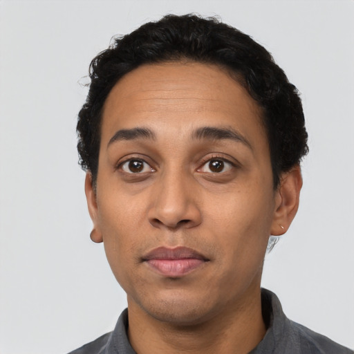 Neutral latino adult male with short  black hair and brown eyes
