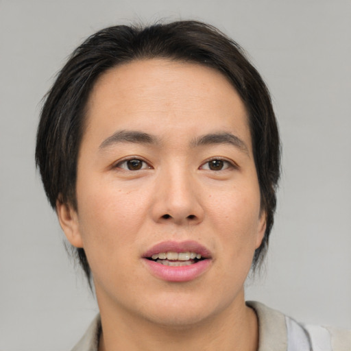 Joyful asian young-adult male with medium  brown hair and brown eyes