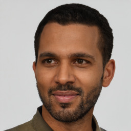 Joyful black young-adult male with short  black hair and brown eyes