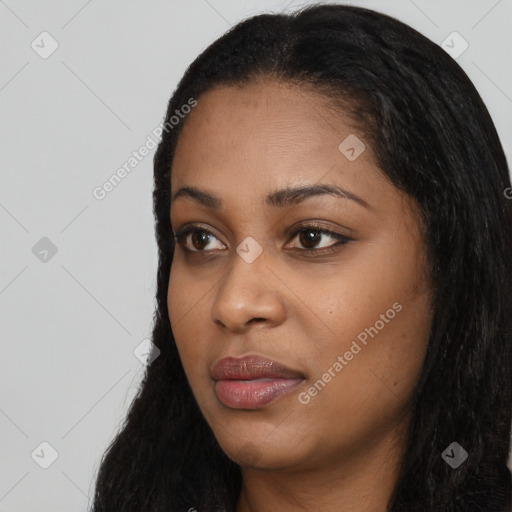 Joyful black young-adult female with long  black hair and brown eyes