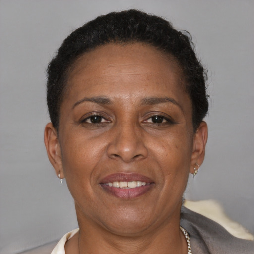 Joyful latino adult female with short  brown hair and brown eyes