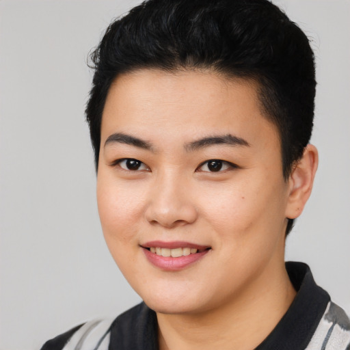 Joyful asian young-adult female with short  black hair and brown eyes