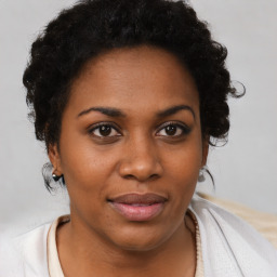 Joyful black young-adult female with short  brown hair and brown eyes