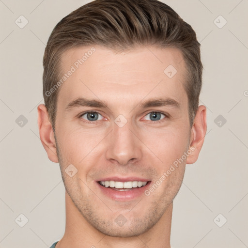 Joyful white young-adult male with short  brown hair and grey eyes