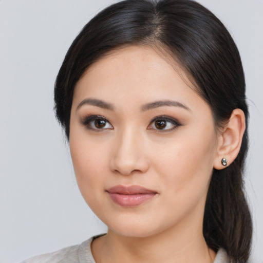 Joyful asian young-adult female with medium  brown hair and brown eyes