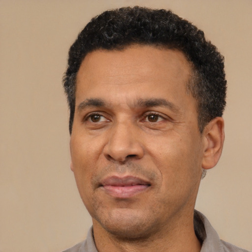 Joyful latino adult male with short  black hair and brown eyes