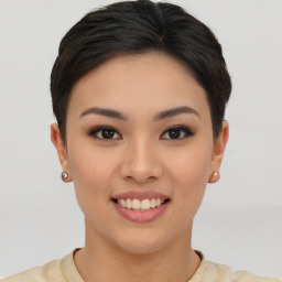 Joyful asian young-adult female with short  brown hair and brown eyes