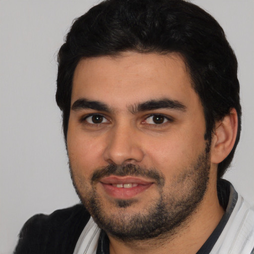 Joyful white young-adult male with short  black hair and brown eyes