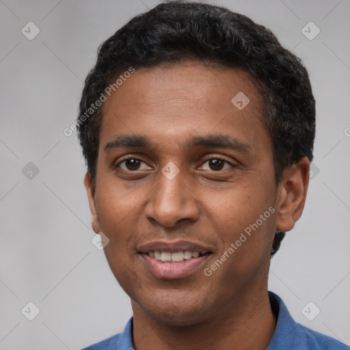 Joyful black young-adult male with short  black hair and brown eyes