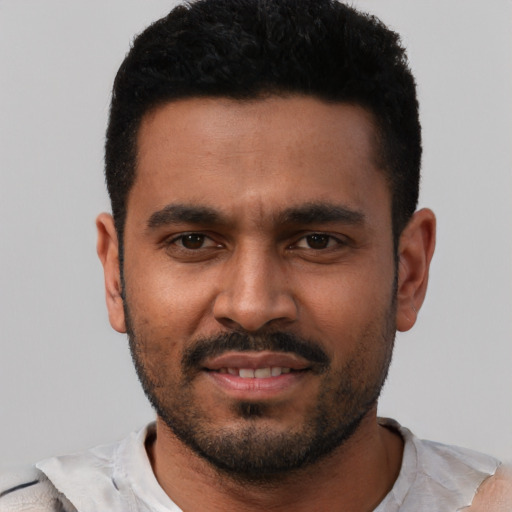 Joyful black young-adult male with short  black hair and brown eyes