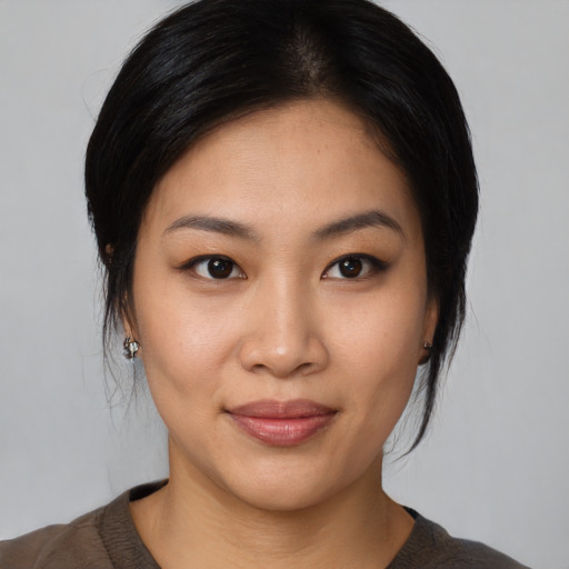 Joyful asian young-adult female with medium  black hair and brown eyes