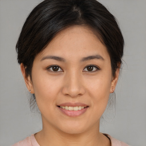 Joyful asian young-adult female with medium  brown hair and brown eyes
