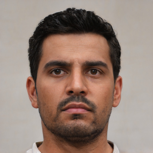 Neutral white young-adult male with short  black hair and brown eyes