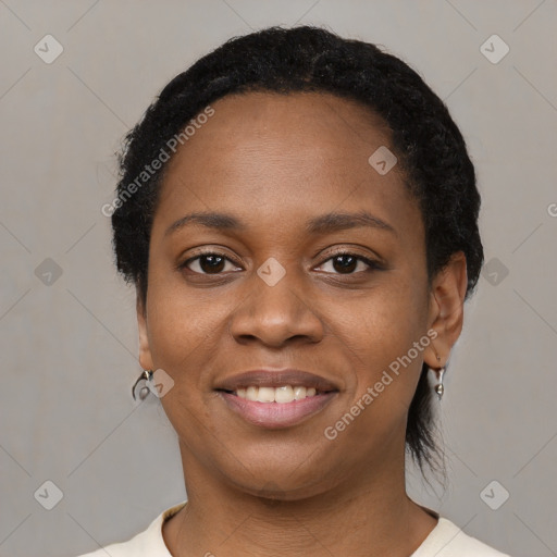 Joyful black young-adult female with short  black hair and brown eyes