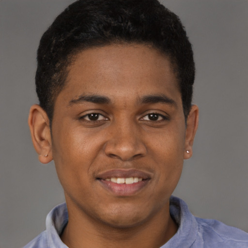 Joyful latino young-adult male with short  brown hair and brown eyes