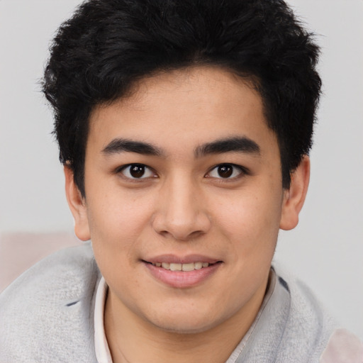 Joyful latino young-adult male with short  brown hair and brown eyes