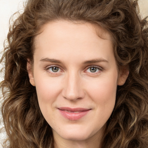 Joyful white young-adult female with long  brown hair and green eyes