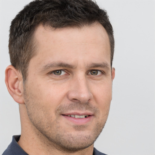 Joyful white adult male with short  brown hair and grey eyes