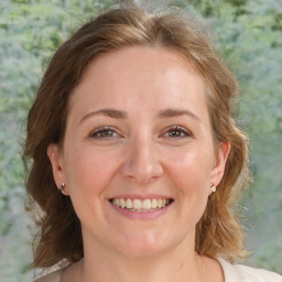 Joyful white adult female with medium  brown hair and brown eyes