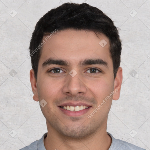 Joyful white young-adult male with short  black hair and brown eyes