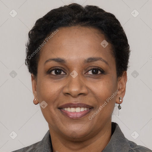 Joyful black adult female with short  brown hair and brown eyes