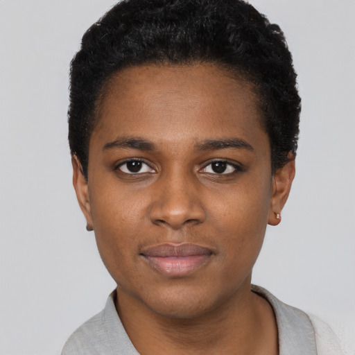 Joyful black young-adult female with short  black hair and brown eyes
