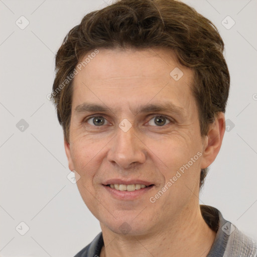 Joyful white adult male with short  brown hair and grey eyes