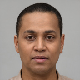 Neutral latino young-adult male with short  brown hair and brown eyes